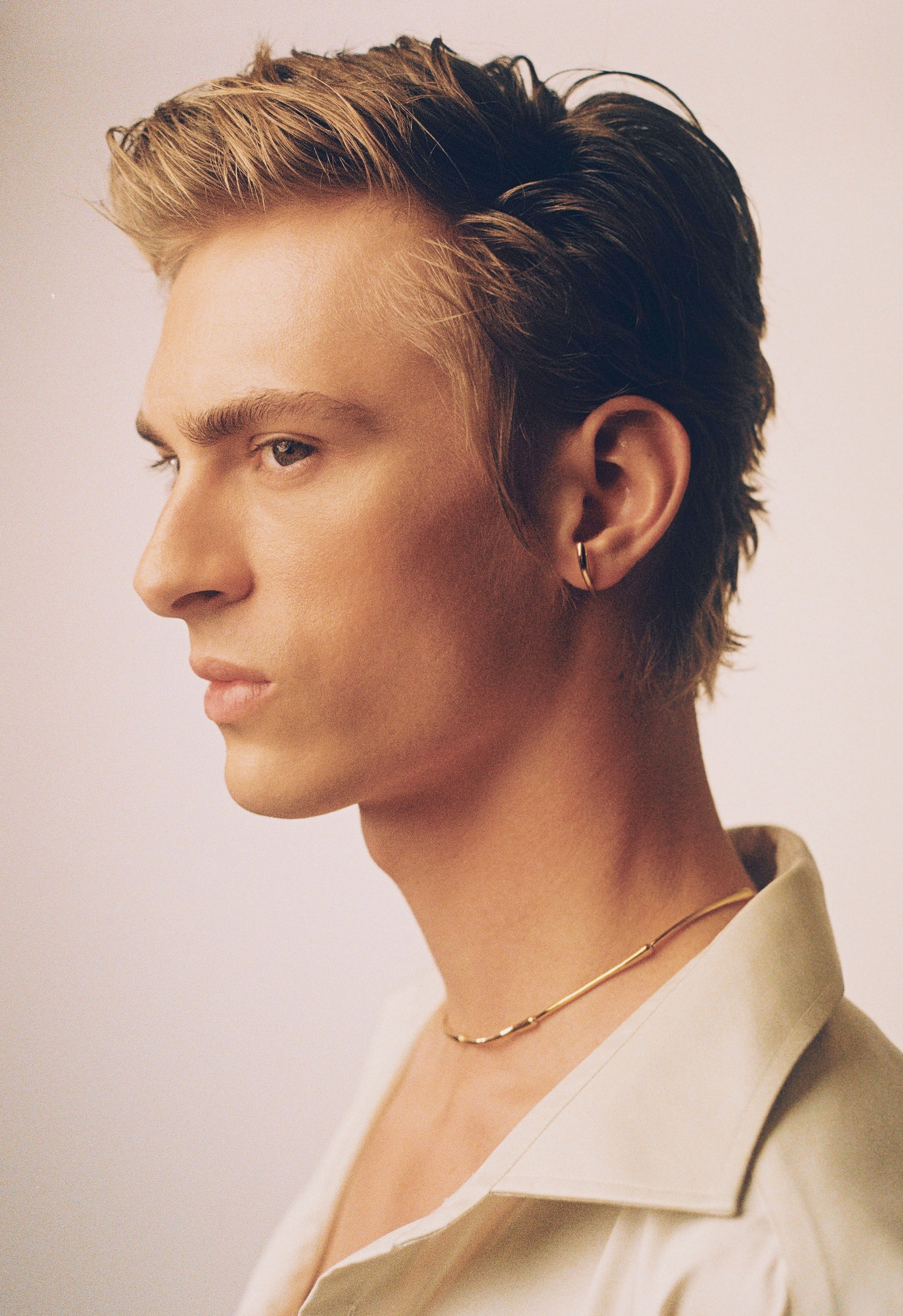 Dominik Sadoch in recycled sustainable gold earrings from Herien collection
